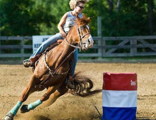 This barrel racer looks delighted, but her barrel horse looks the opposite.